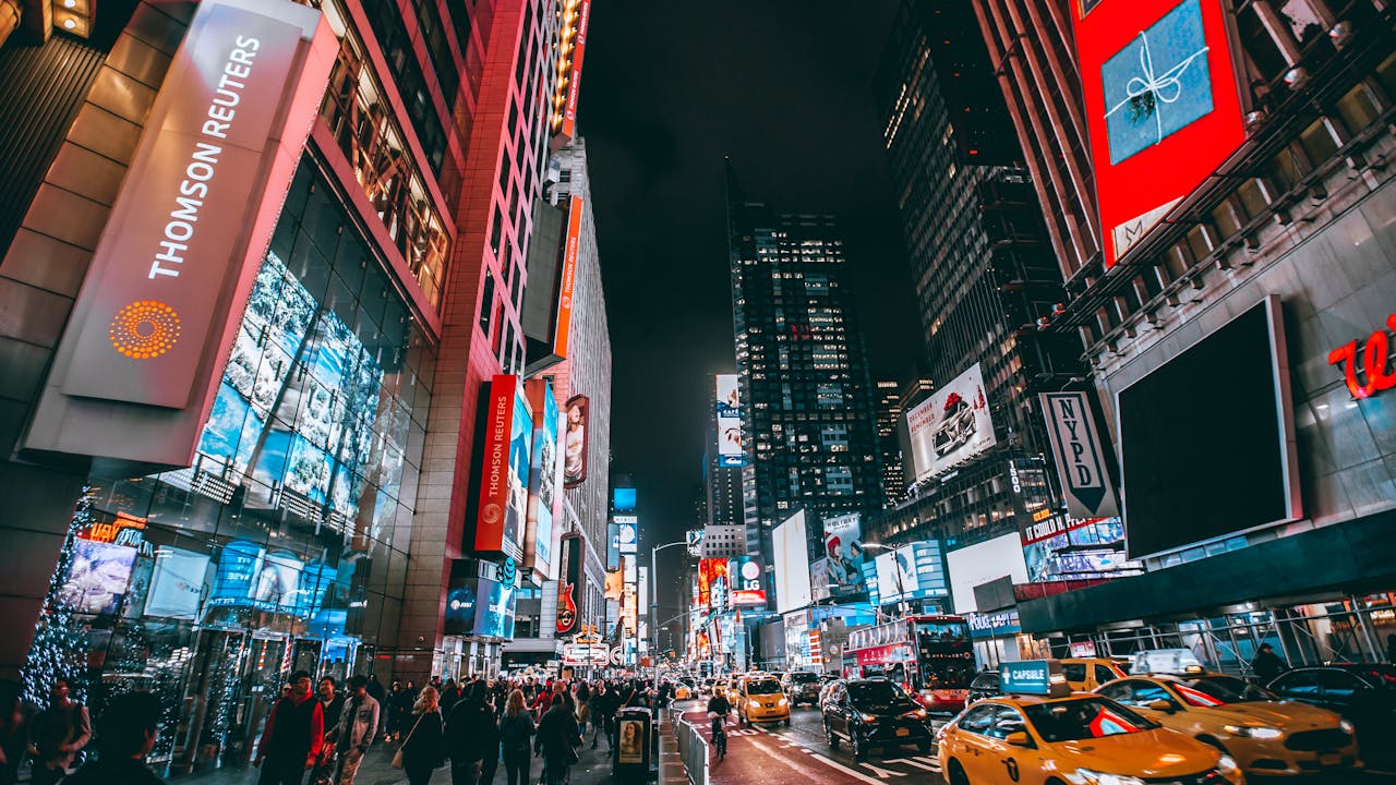 portfolio-02 Bustling evening scene in New York City's iconic Times Square, showcasing bright lights and lively atmosphere.